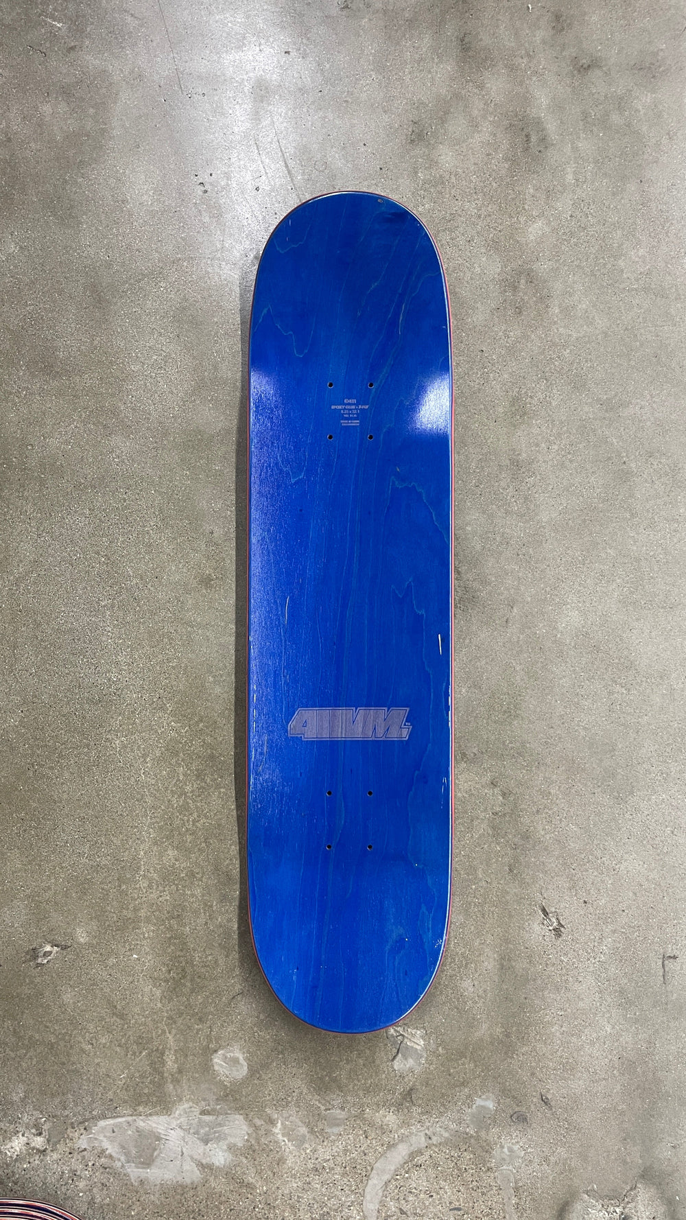 Top view of 411VM Athletic 93 8.5-inch deck with blue wood stain and laser-etched 411VM logo