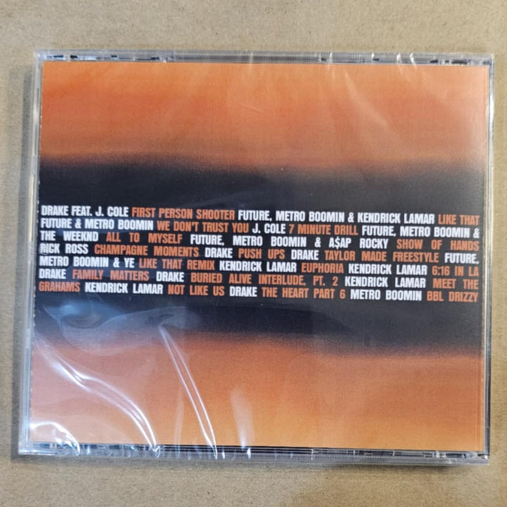 CD case with orange and black design on a beige surface