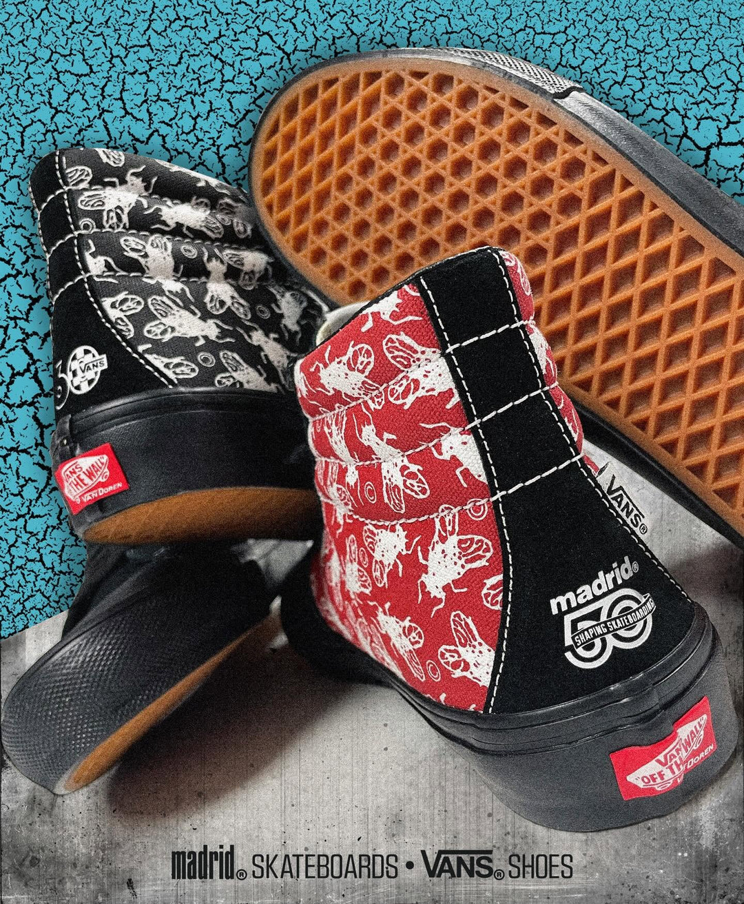 A pair of Vans mid-top sneakers with a black and red bee-patterned canvas upper, black suede heel panels, and a red Vans logo heel tab, shown on a textured gray surface with a blue crackle-patterned background.