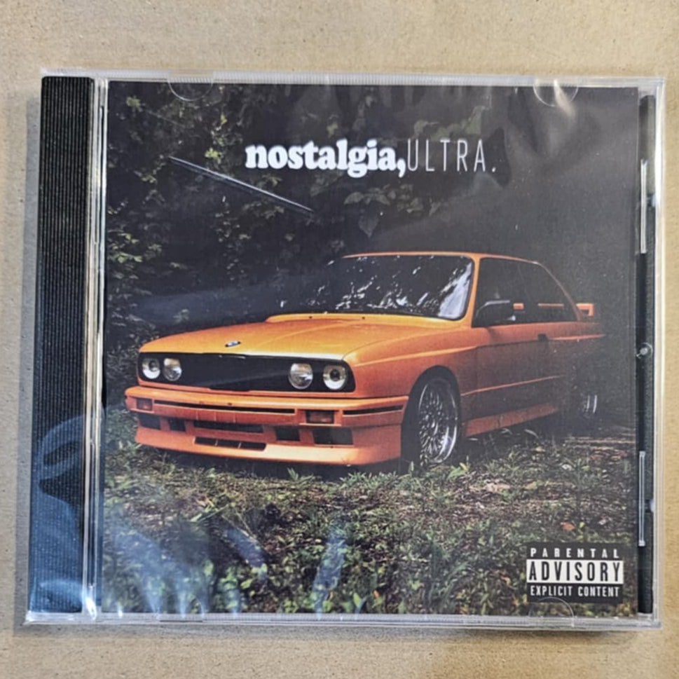 CD cover with a car illustration and 'nostalgia Ultra' branding on a beige surface