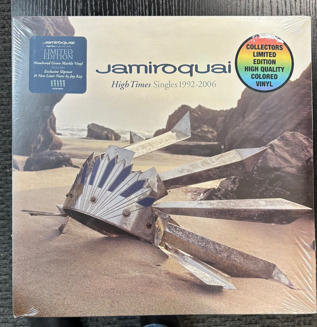 Vinyl record packaging for Jamiroquai's 'High Times Singles 1992-2006' with a desert landscape design.