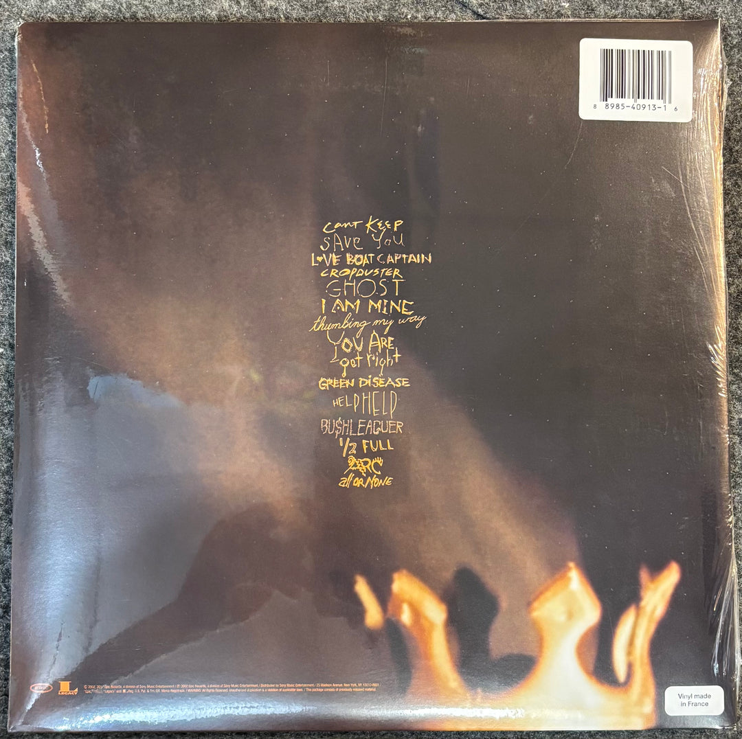 Back cover of Pearl Jam – Riot Act with text and flames design