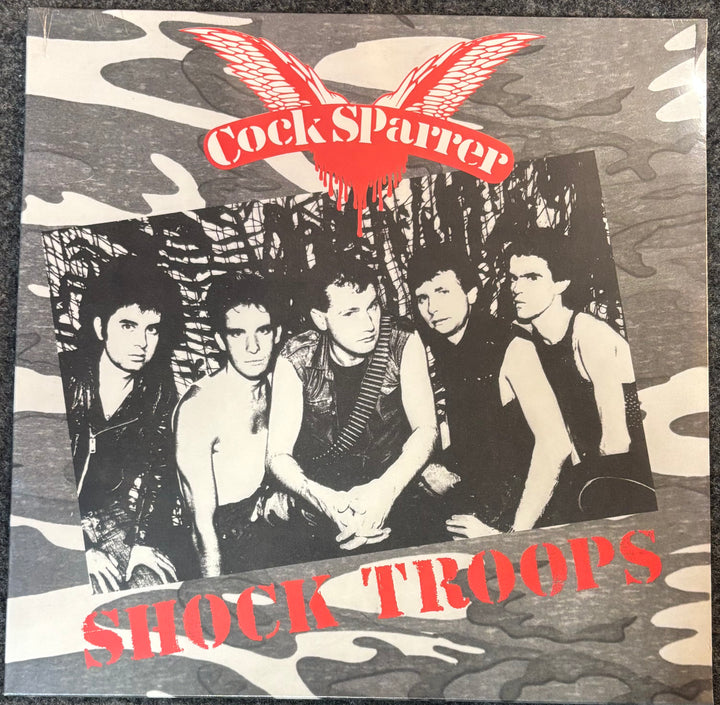 Album cover with band members and 'Cock Sparrer' text on a camouflage background