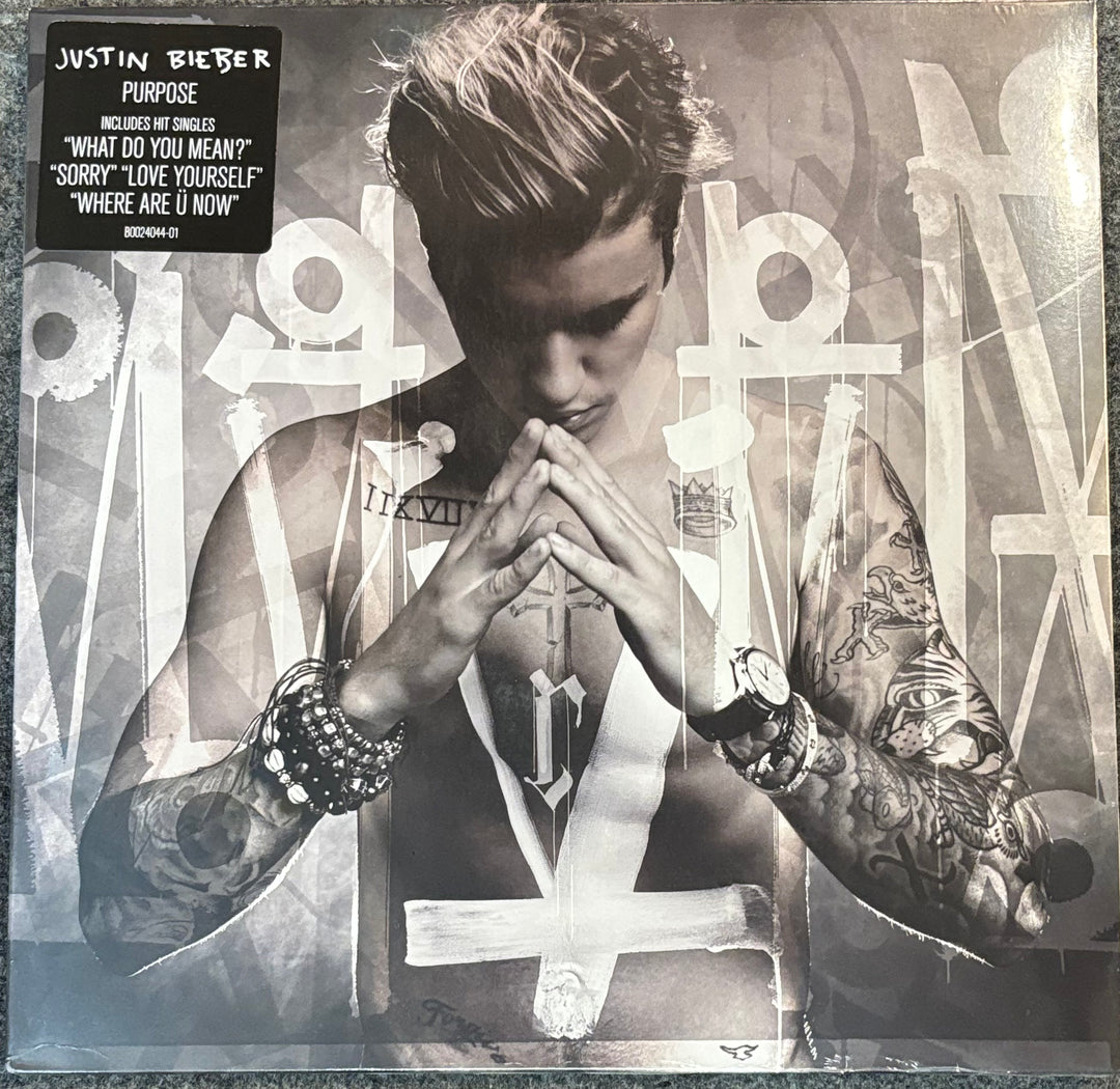 BIEBER, JUSTIN – PURPOSE cover with a person with tattoos and text at the top