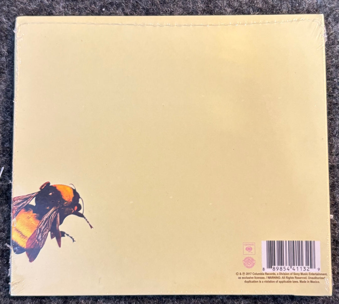 TYLER, THE CREATOR – FLOWER BOY cd back cover with a bee illustration and barcode on a textured surface