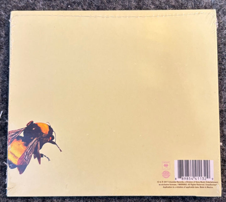 TYLER, THE CREATOR – FLOWER BOY cd back cover with a bee illustration and barcode on a textured surface