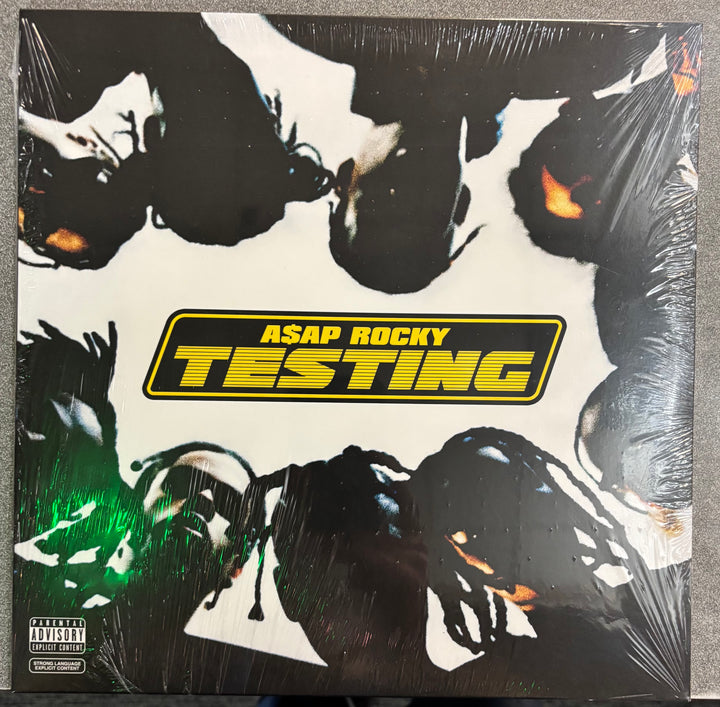 Album cover for A$AP Rocky's 'Testing' with stylized faces and prominent text.