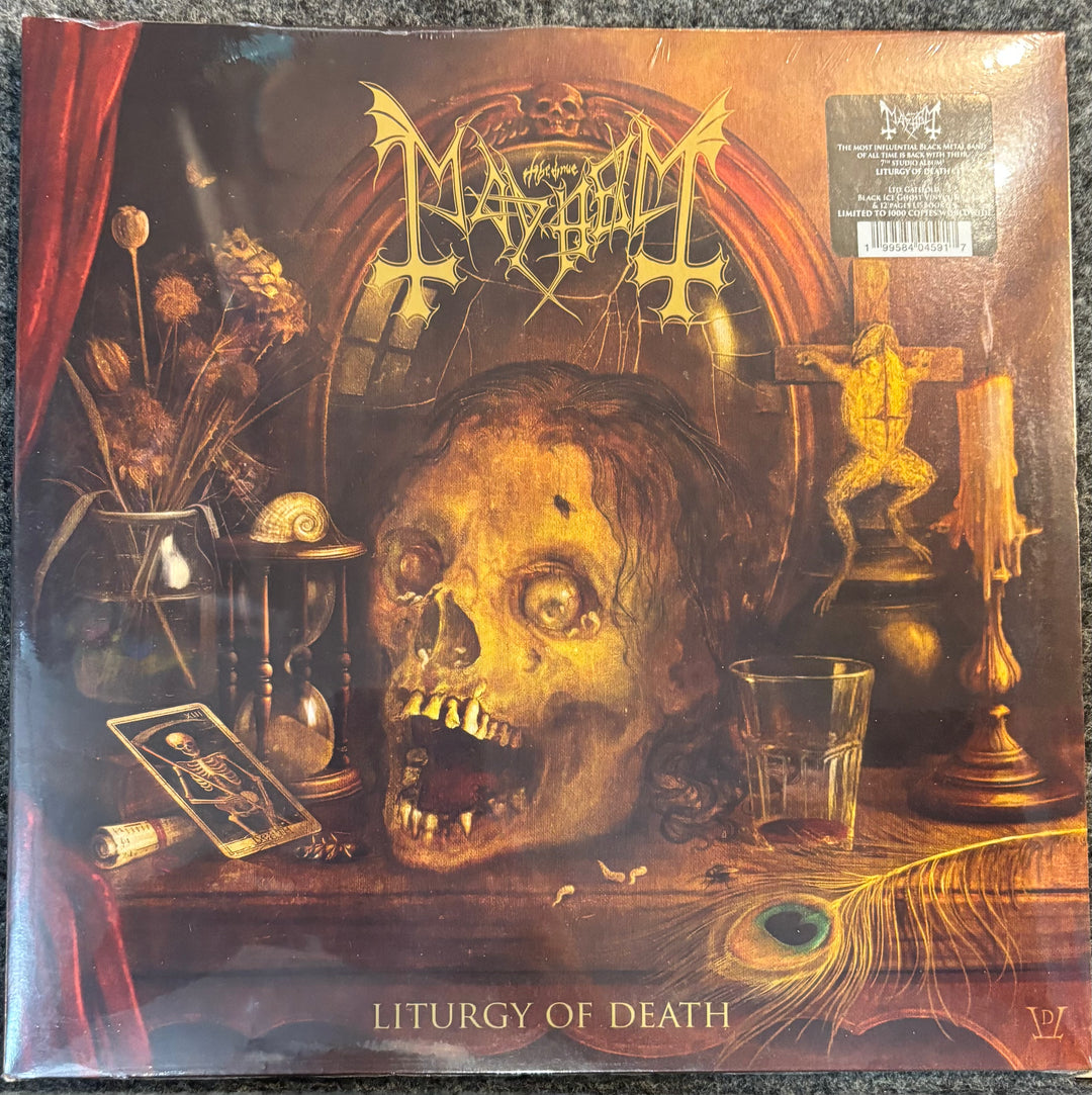 MAYHEM – LITURGY OF DEATH record cover with a skull, hourglass, and other objects on a table, featuring the band Mayhem and album title 'Liturgy of Death'.
