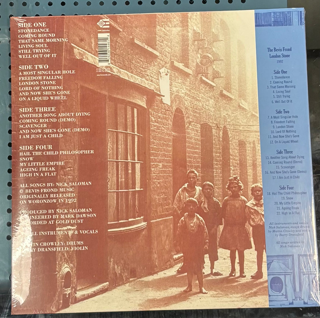 The back cover of a vinyl record sleeve for The Bevis Frond - London Stone, featuring a sepia-toned photograph of children in front of a brick building, track listings on the left, and a blue sidebar on the right.