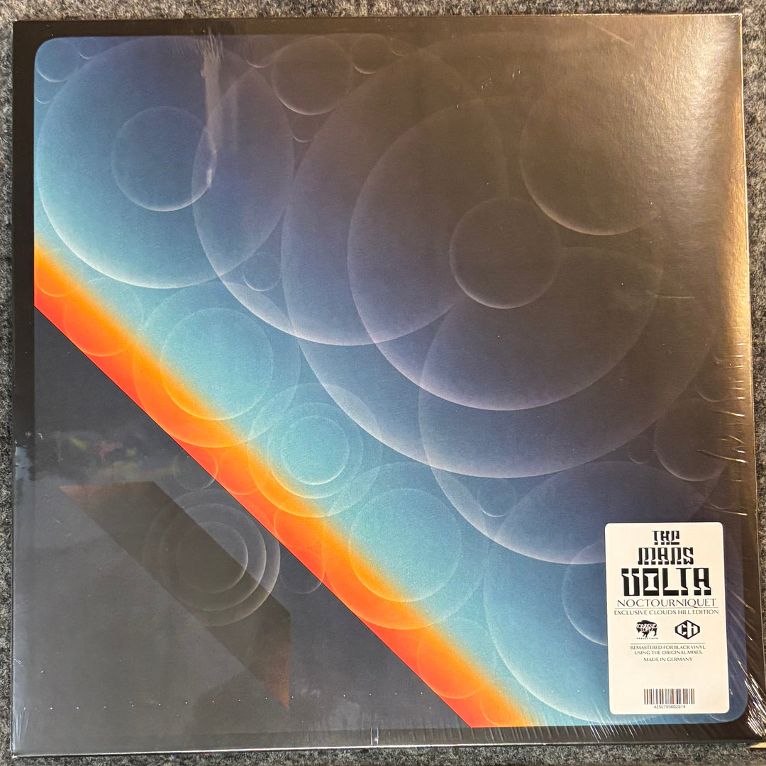 THE MARS VOLTA - NOCTOURNIQUET record with a colorful cover featuring concentric circles and a label on a textured surface.