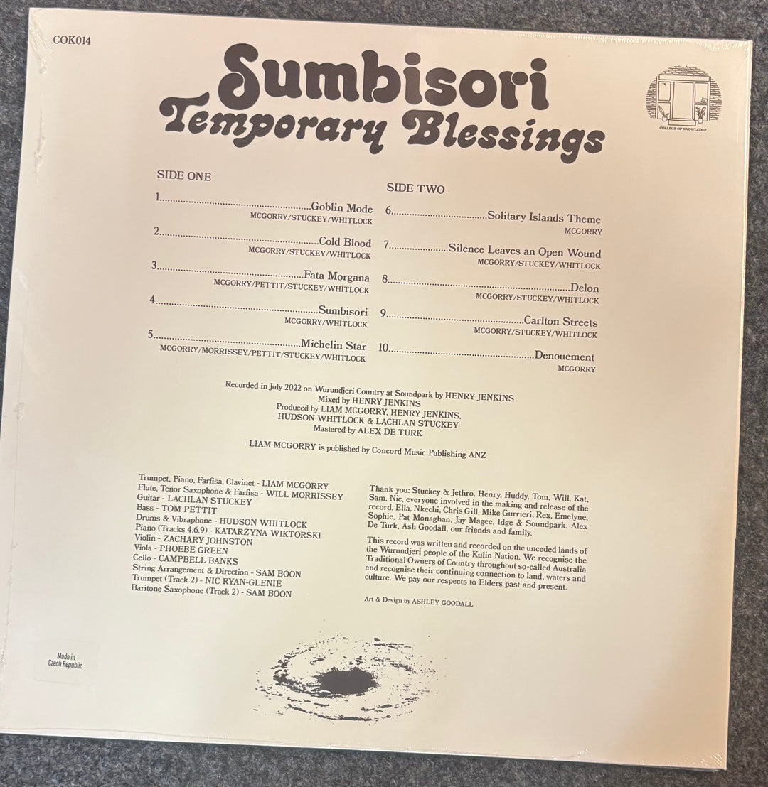 A vinyl record sleeve for Sumbisori - Temporary Blessings, photographed flat on a light beige background. The sleeve features black typography with track listings for Side One and Side Two, along with a small Mercury Will Rock logo in the top right corner.