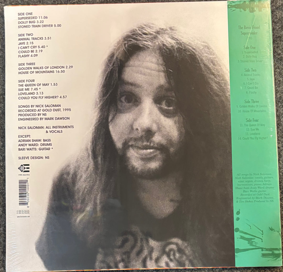 The back cover of The Bevis Frond - Superseeder album, featuring a large black-and-white portrait of a woman, track listings, and a green spine band on a dark textured surface.