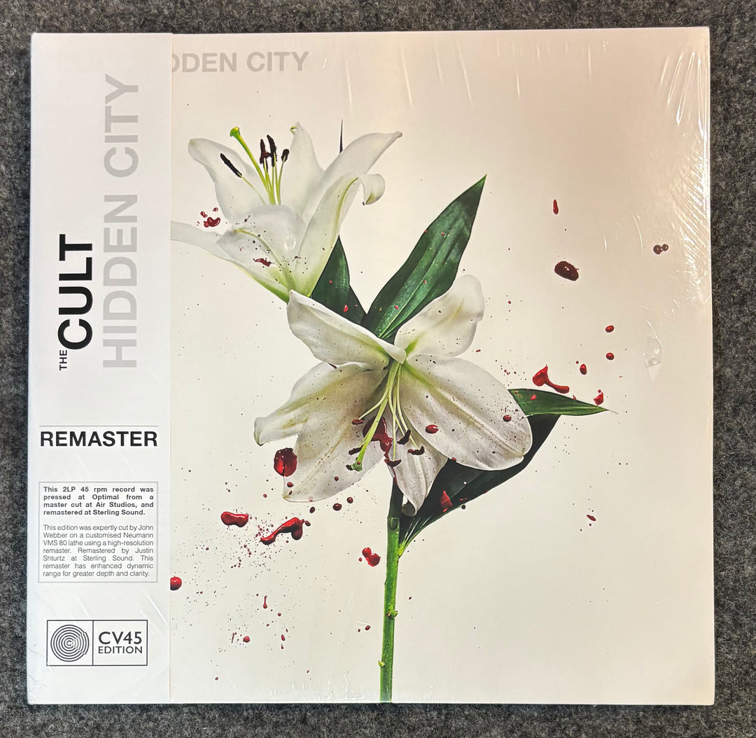 CULT, THE – HIDDEN CITY record cover with white lilies and text on a gray surface