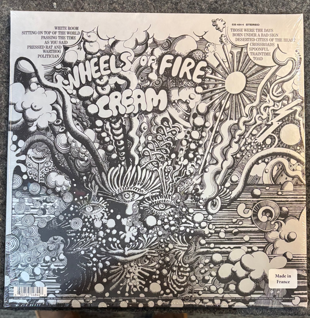 CREAM - Wheels Of Fire Album cover with intricate design and text 'Wheels of Fire Cream' on a textured surface.