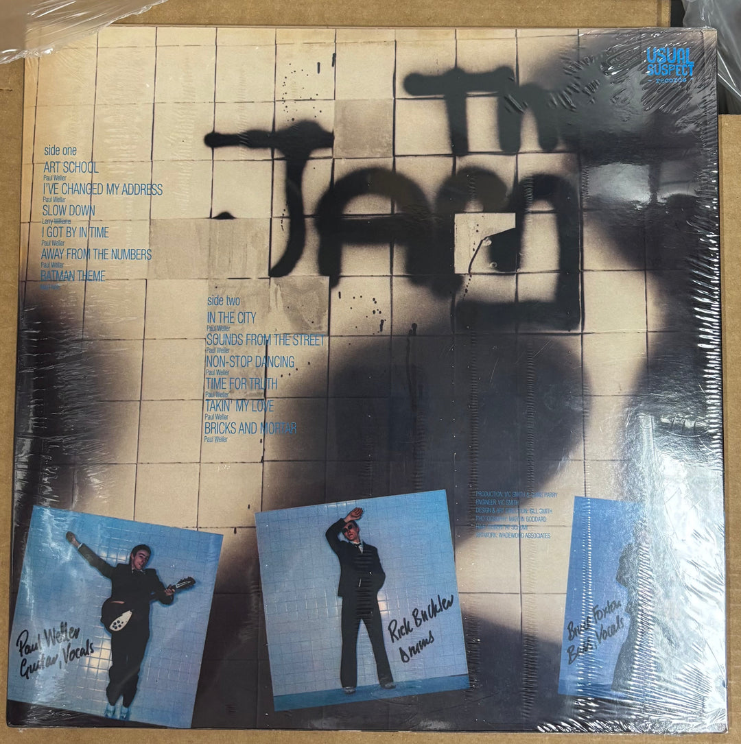 Vinyl record cover with text and images of a person on a tiled background