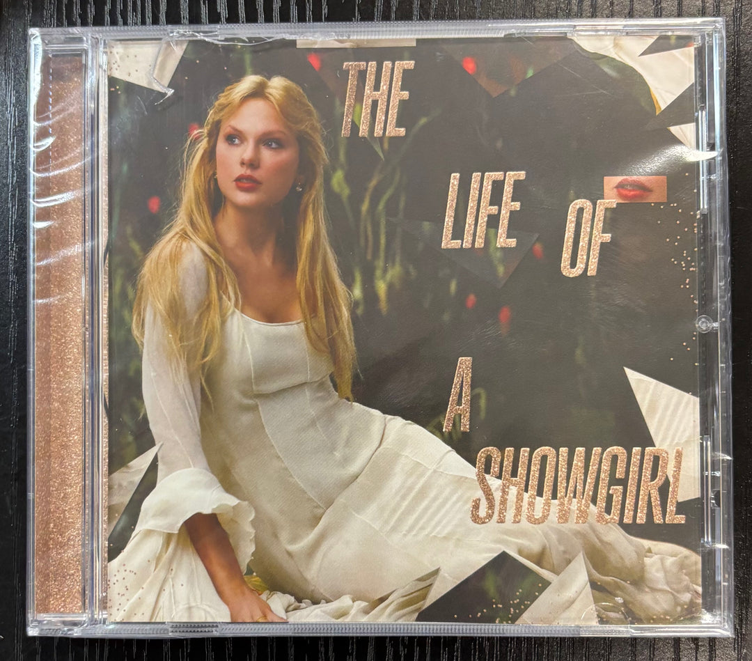 CD cover of 'The Life of a Showgirl' with a woman in a white dress.