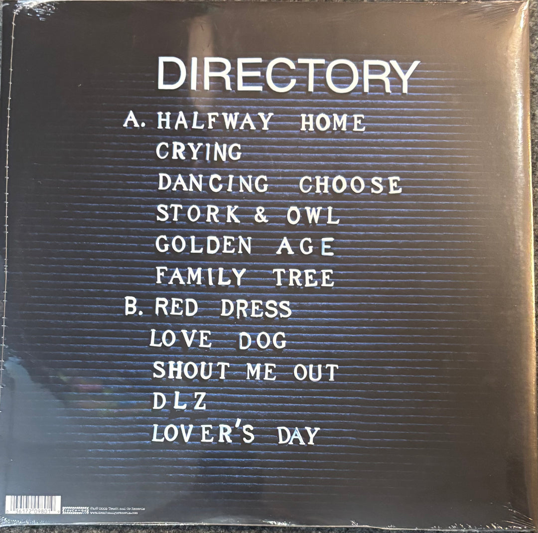 The back cover of a vinyl record sleeve for the album TV On The Radio - Dear Science, featuring a black background with white text listing track titles and a barcode at the bottom left.