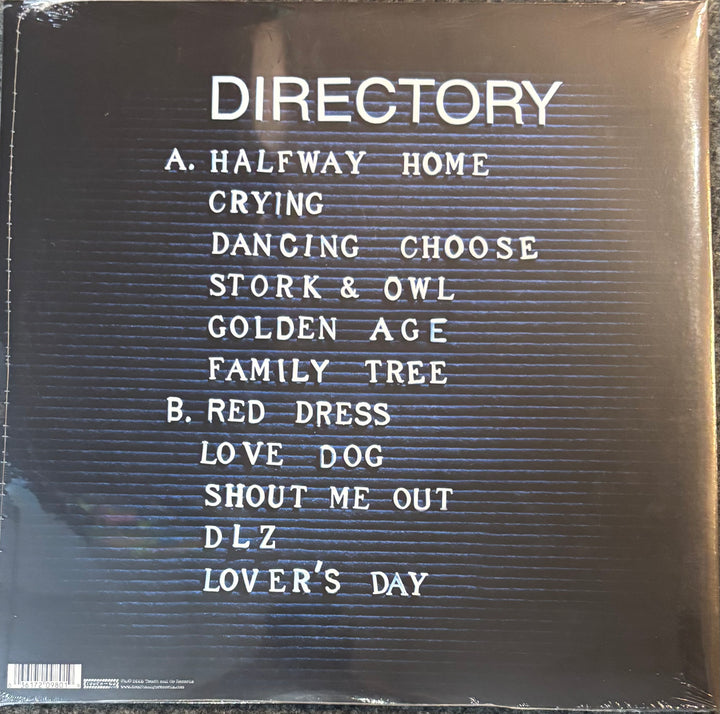 The back cover of a vinyl record sleeve for the album TV On The Radio - Dear Science, featuring a black background with white text listing track titles and a barcode at the bottom left.