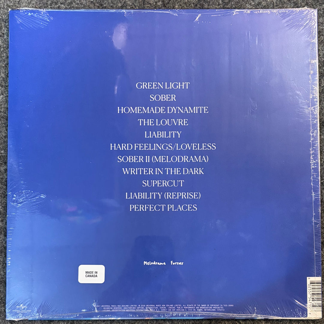 The back cover of Lorde - Melodrama, sealed in plastic shrink wrap, showing the tracklist in white text on a blue background.