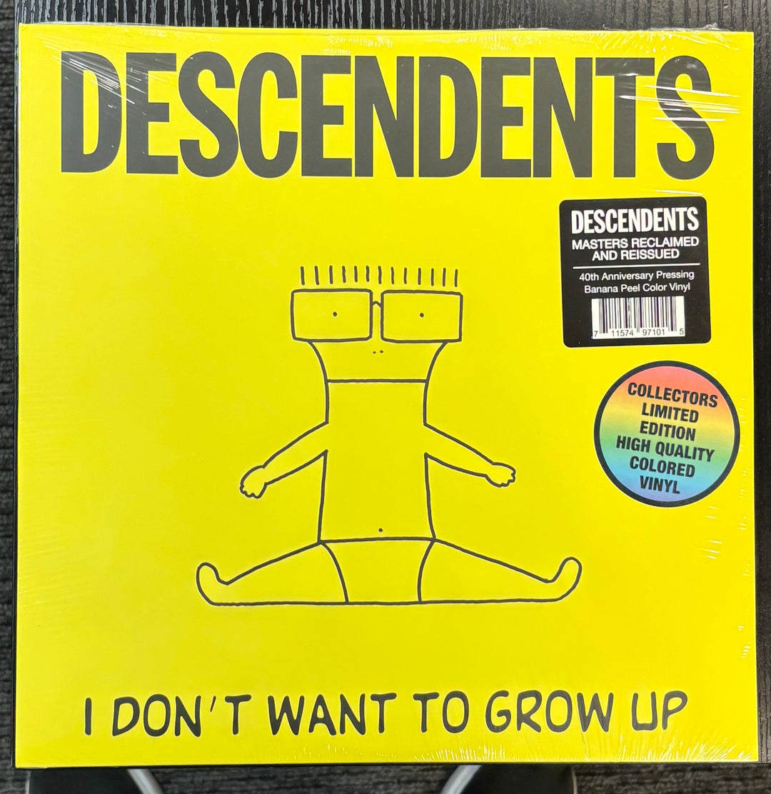 Vinyl record cover for 'I Don't Want to Grow Up' by Descendents with yellow background and black text.