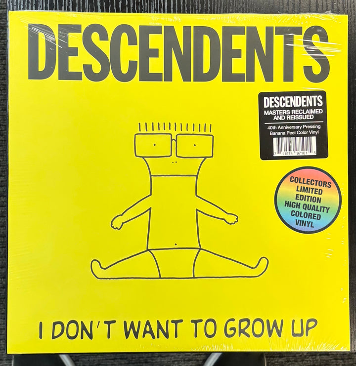 Vinyl record cover for 'I Don't Want to Grow Up' by Descendents with yellow background and black text.