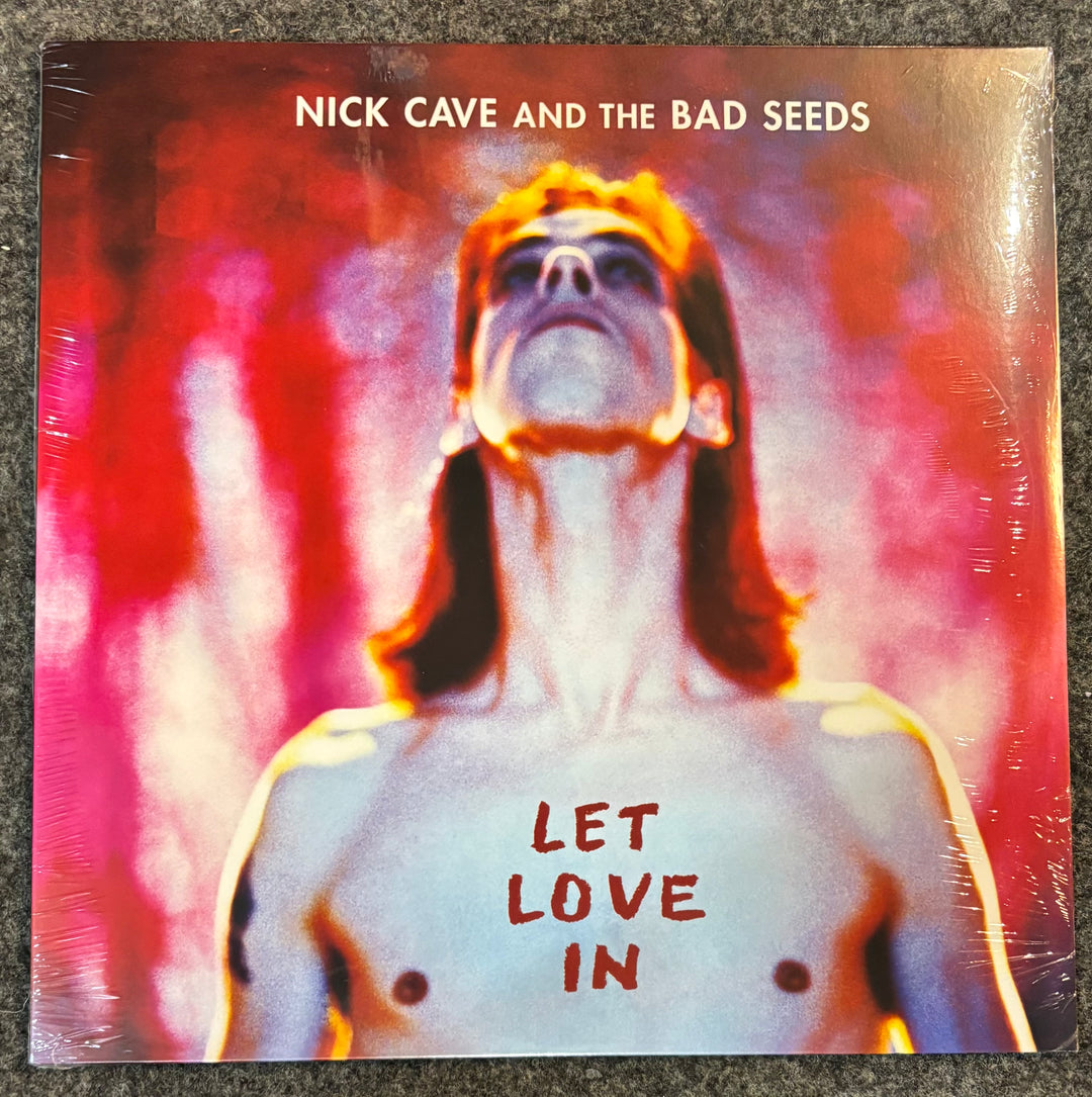 Album cover of 'Let Love In' by Nick Cave and the Bad Seeds with a person's face and text.