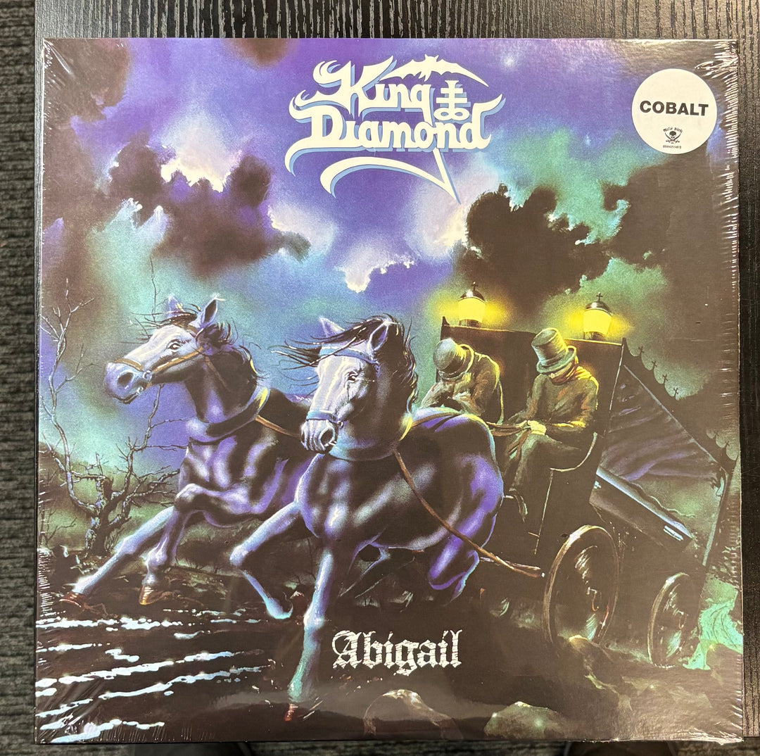 Album cover for 'Abigail' by King Diamond featuring a horse-drawn carriage and horses.
