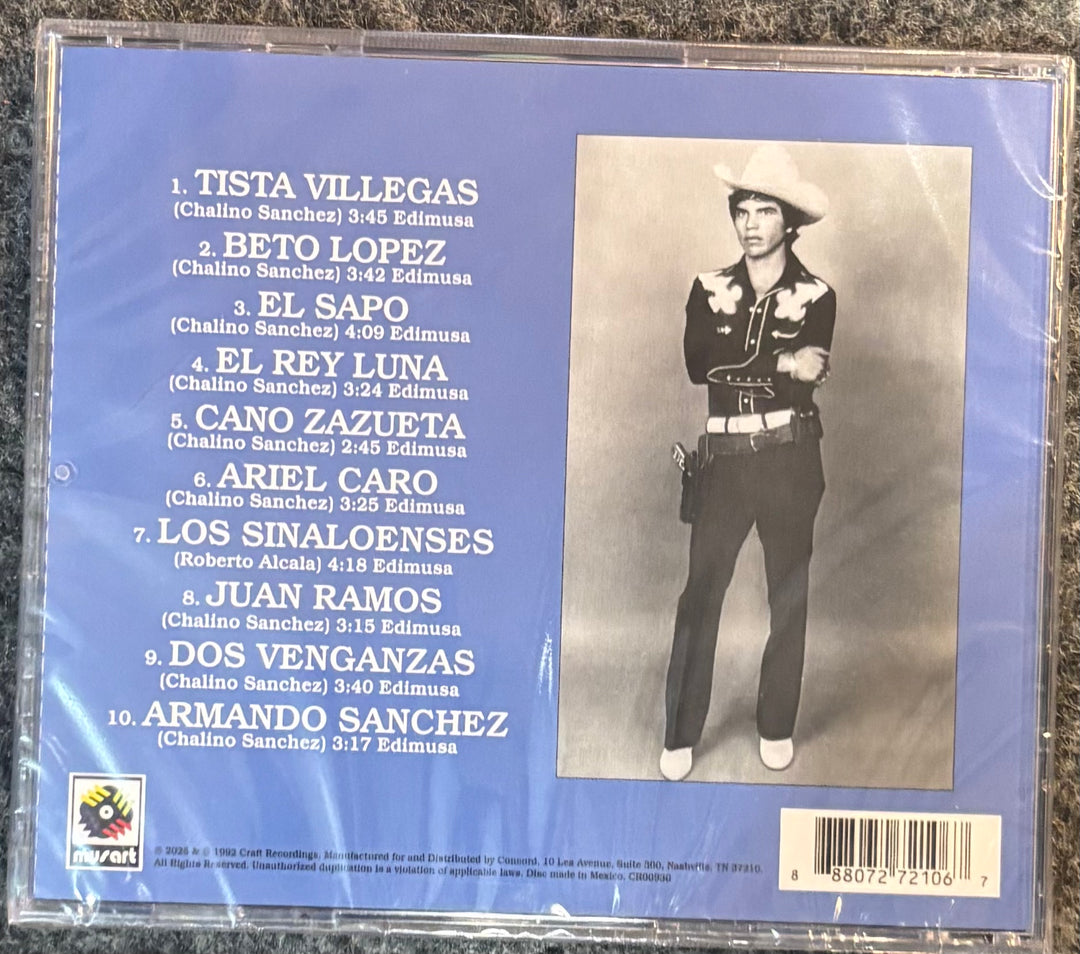 SANCHEZ, CHALINO - MAS EXITOS CON CHALINO SANCHEZ cover with a list of songs and a black and white photo of a person in traditional attire on a blue background.