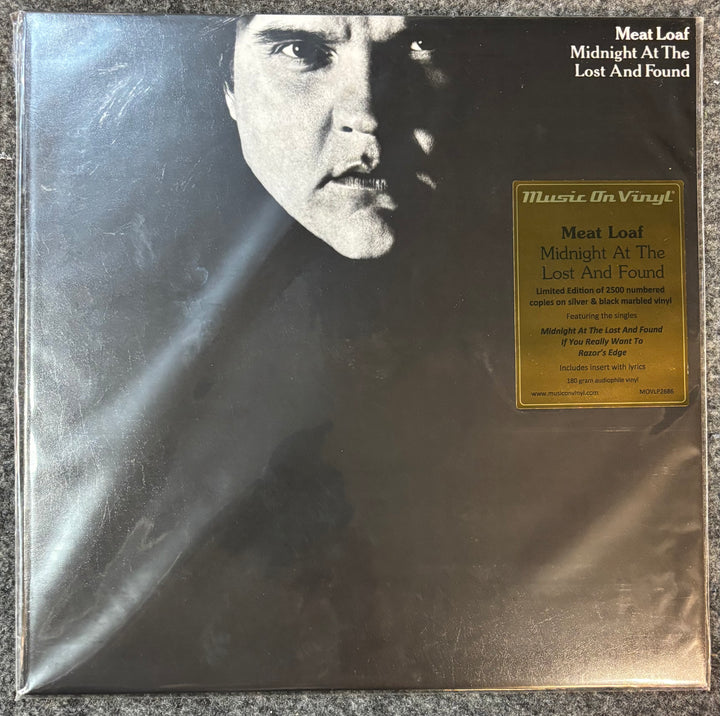 Meat Loaf – Midnight At The Lost And Found vinyl record cover with a black and white portrait and gold label on a textured surface