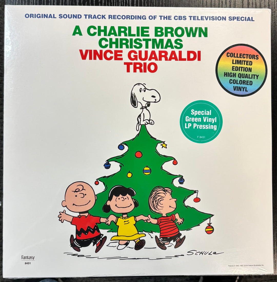 Vinyl record cover for 'A Charlie Brown Christmas' by Vince Guaraldi Trio with cartoon characters around a Christmas tree.
