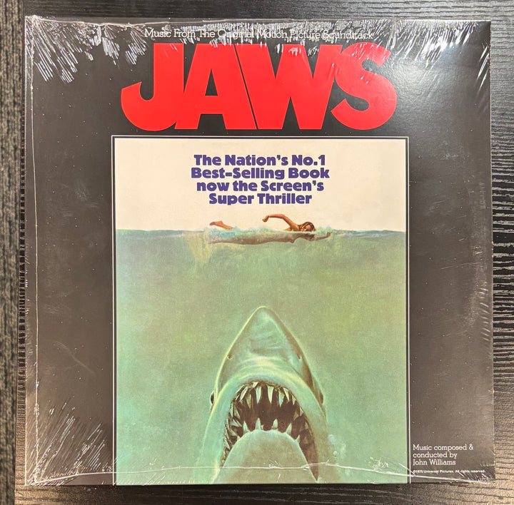 Vinyl record cover for 'Jaws' with shark and swimmer illustration