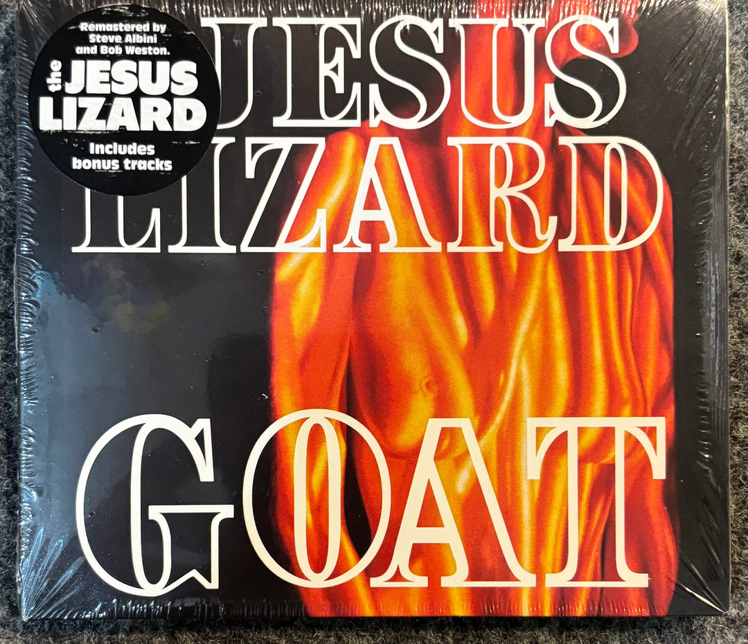 The Jesus Lizard -Goat, sealed in shrink wrap with a black 'Jesus Lizard' sticker on the top left, featuring a black background and a large orange and yellow flame graphic.