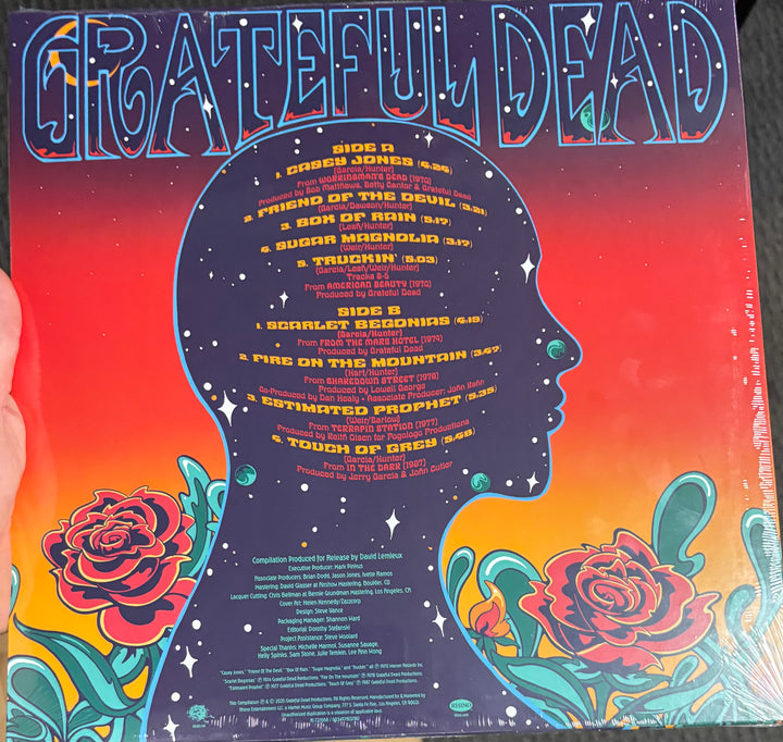 Grateful Dead - Gratest Hits record cover with 'Grateful Dead' branding and colorful design elements.
