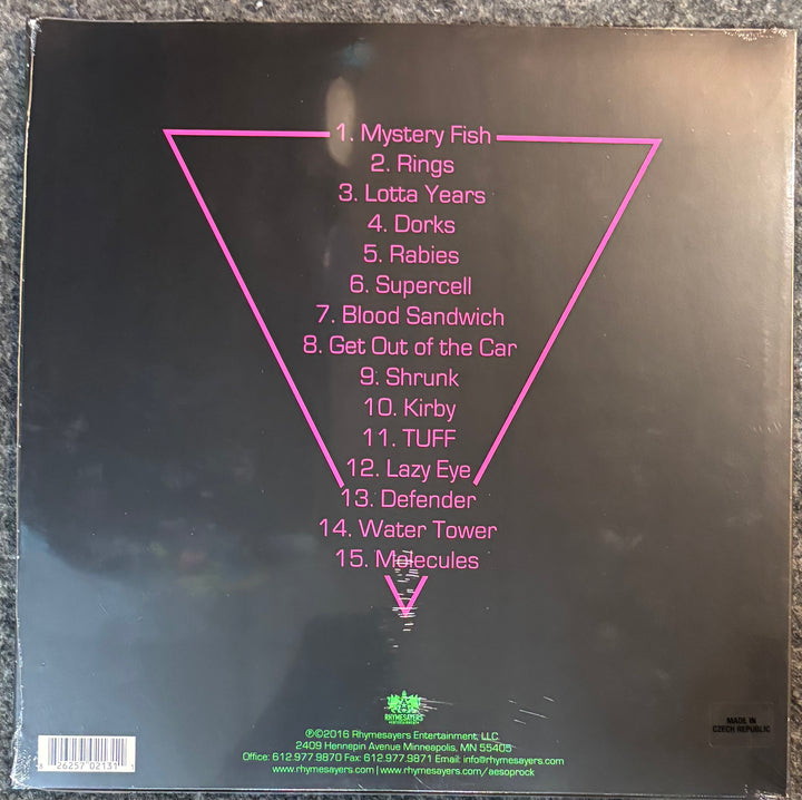 The back cover of Aesop Rock – The Impossible Kid, featuring the tracklist in pink text inside a large pink inverted triangle on a black background.