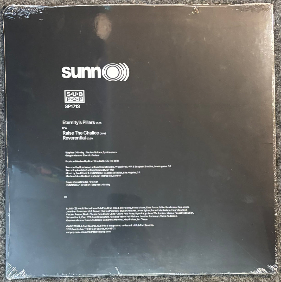 The back cover of a vinyl record sleeve for Sunn O))) - Eternity's Pillars, featuring tracklistings for 'Eternity's Pillars', 'Rise The Chalice', and 'Renewable Sun' on a dark reflective background.