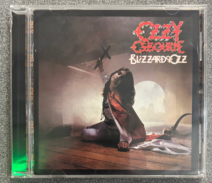 CD cover of 'Blizzard of Ozz' by Ozzy Osbourne with a person holding a cross.