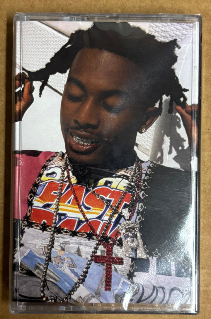 Cassette tape with a person wearing a colorful shirt and chains on a textured beige background