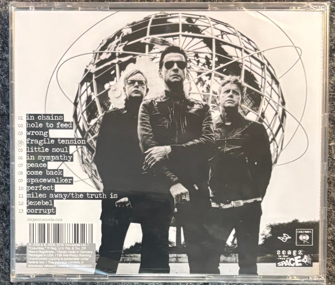 DEPECHE MODE – SOUNDS OF THE UNIVERSE cover with three people in front of a geometric design, featuring text and a barcode.