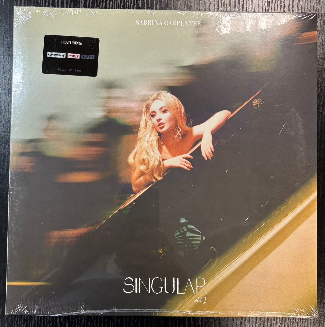 Vinyl record cover for 'Singular' by Sabrina Carpenter with a blurred image of a woman leaning out of a car window.