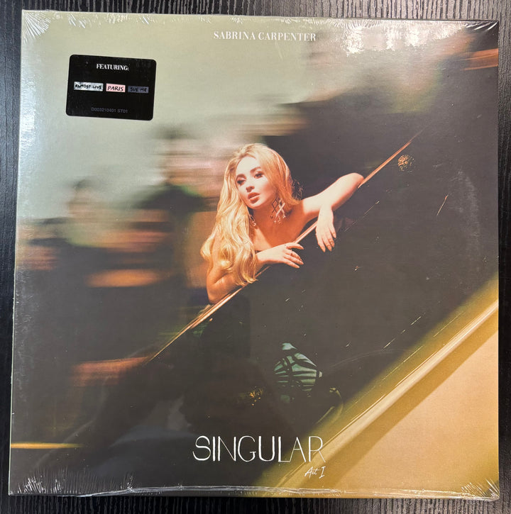 Vinyl record cover for 'Singular' by Sabrina Carpenter with a blurred image of a woman leaning out of a car window.