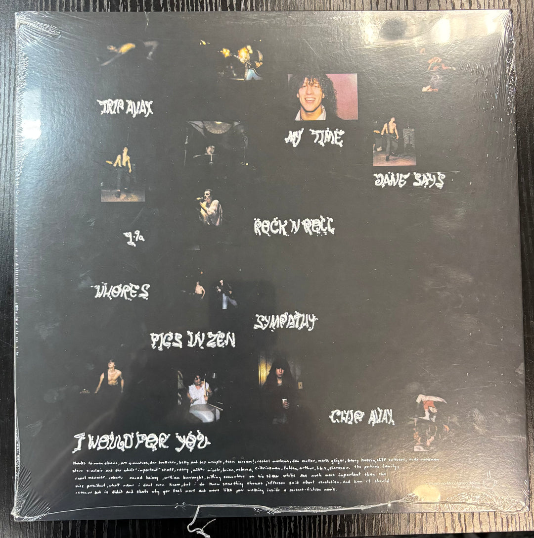 Back cover of a JANE'S ADDICTION record with text and images on a black background