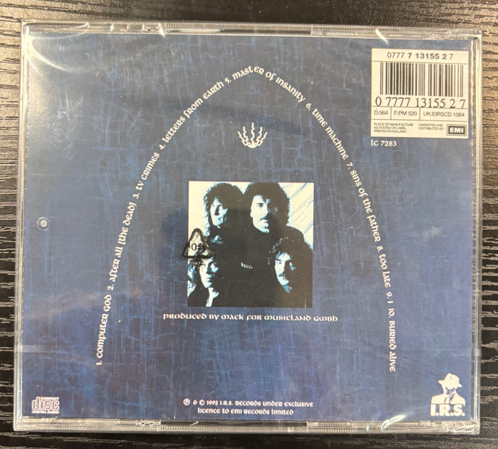 Back cover of Black Sabbath Dehumanizer album with text and a small image of three people on a blue background