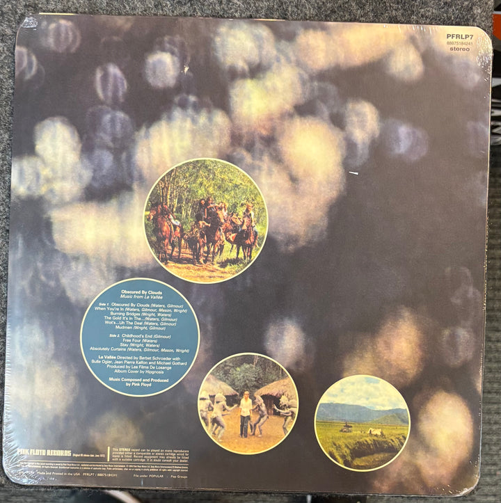 Pink Floyd – Obscured By Clouds record sleeve with scenic images and text on a textured surface