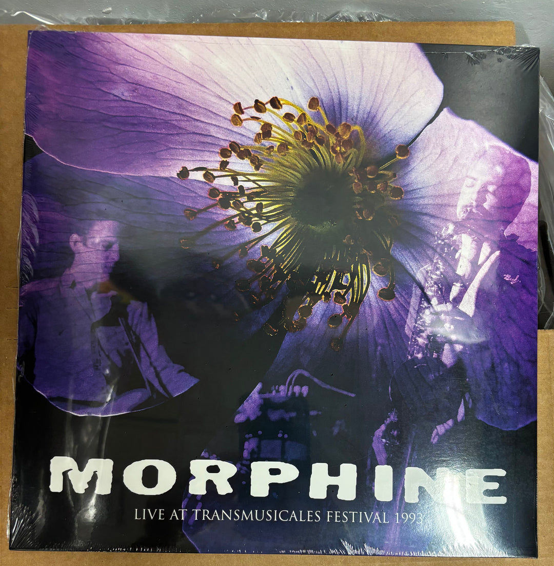 Vinyl record cover with a purple flower and text 'Morphine Live at Transmusicales Festival 1993' on a brown surface.