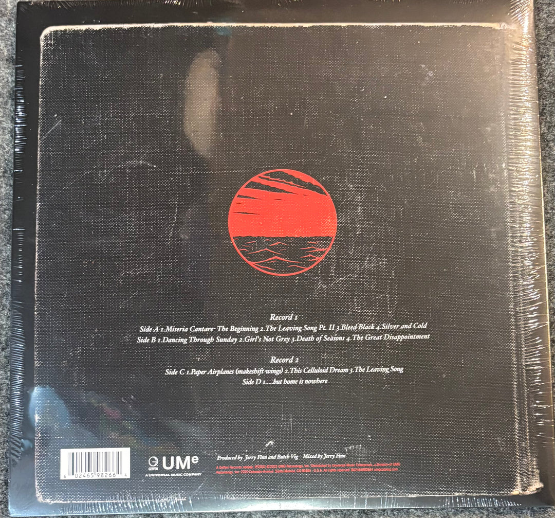 Back cover of a vinyl record with a red circular design and text.