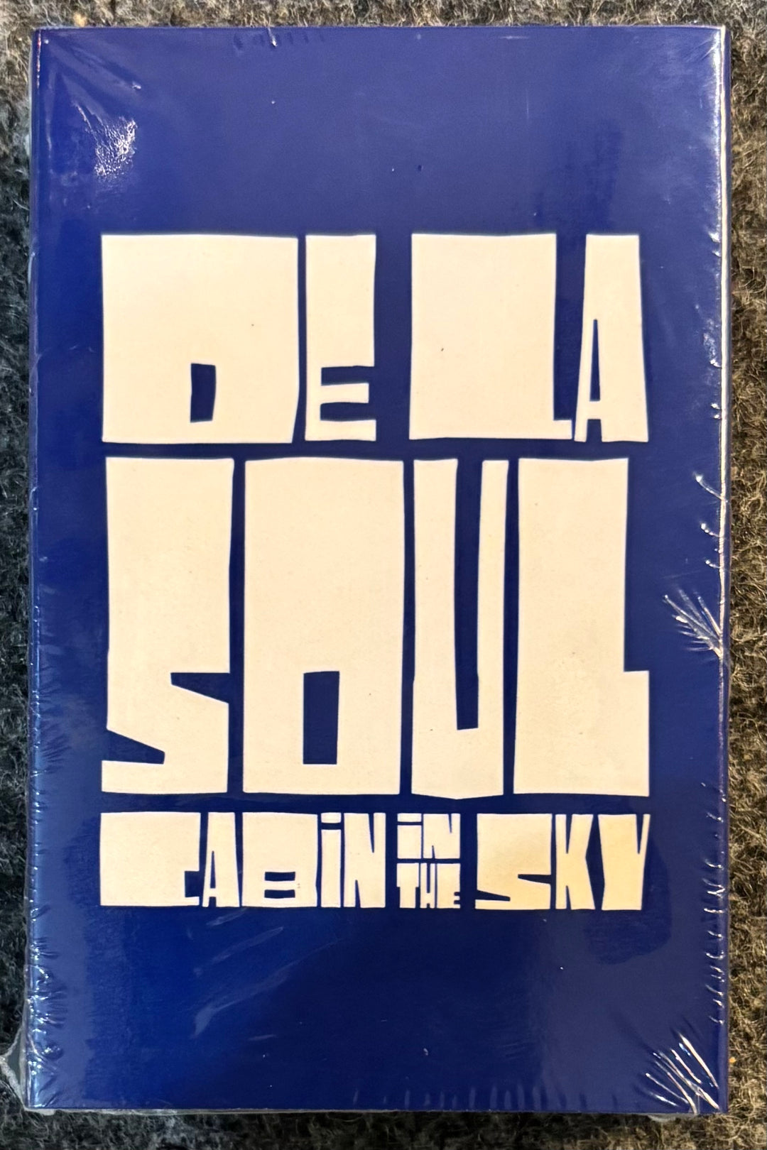 DE LA SOUL - CABIN IN THE SKY cassette with 'De La Soul' and 'Eldin in the Sky' on a blue background