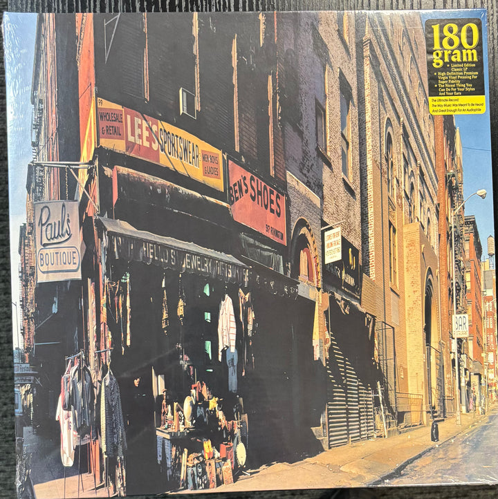 Beastie Boys ‎– Paul's Boutique record cover with a street scene of vintage shops and signs.