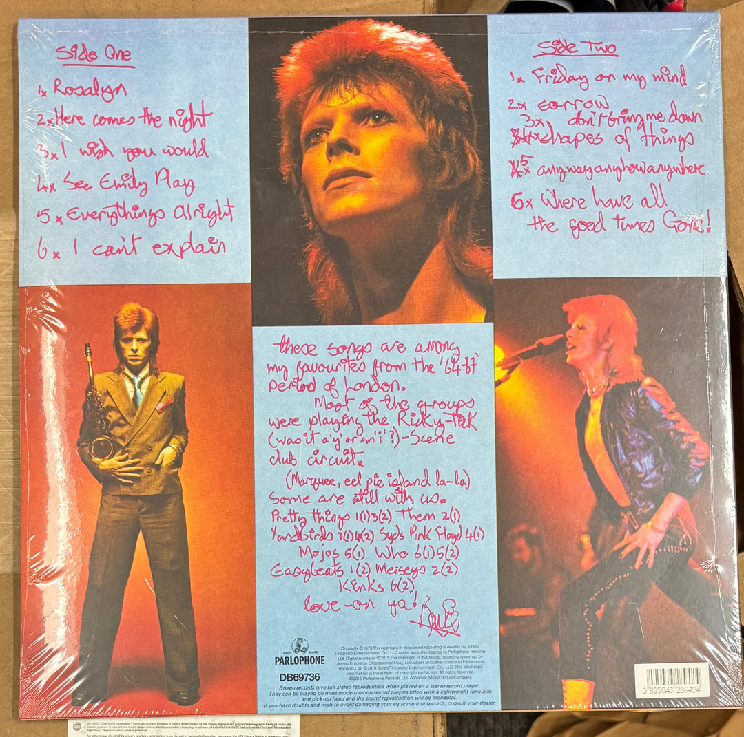BOWIE, DAVID – Pinups Vinyl record cover with a person, text, and musical instruments on a wooden surface