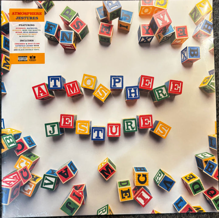 Atmosphere Jestures vinyl record cover art, featuring colorful alphabet blocks spelling 'ATMOSPHERE JESTURES' on a white background, with the orange and black album cover details visible in the top left corner.