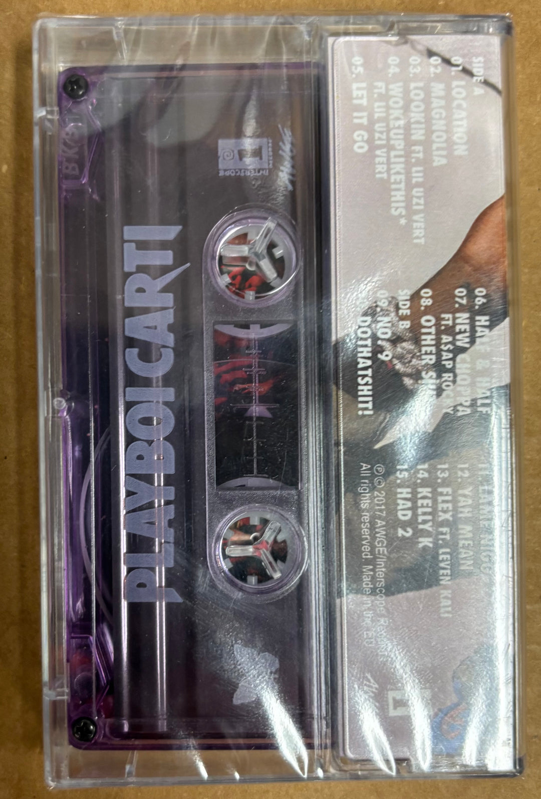 Cassette tape with 'Playboi Carti' branding on a beige background